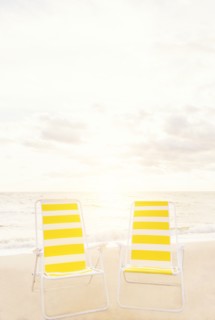 Two empty chairs on beach