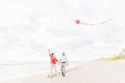 Couple flying kite together on beach