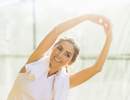 Portrait of young woman stretching