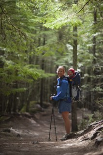 Woman with son (4-5) on trail of cedars