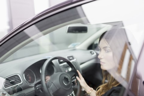 Young woman sitting in car