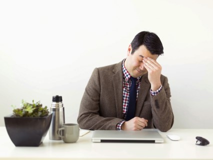 Tired man sitting in office
