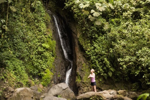 Woman under waterfall