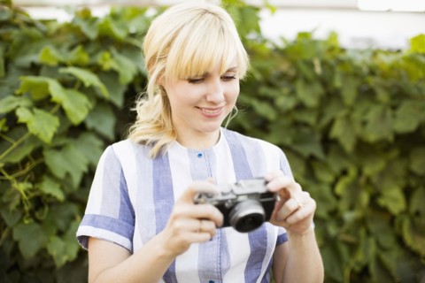 Blonde woman with digital camera