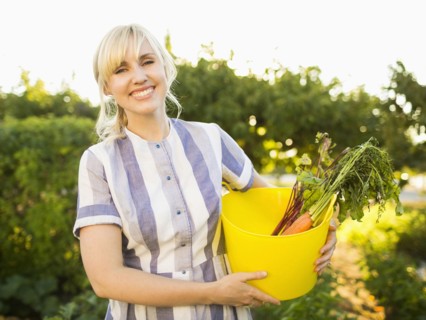 Woman picking vegetables in garden
