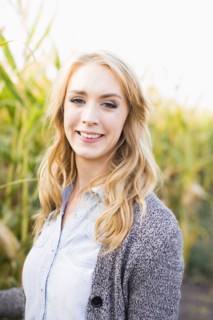 Portrait of young woman in corn field
