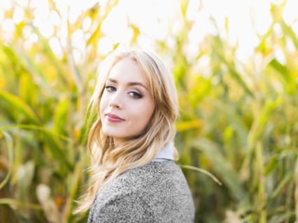 Portrait of young woman in corn field
