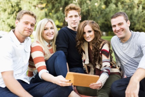 Portrait of friends with digital tablet