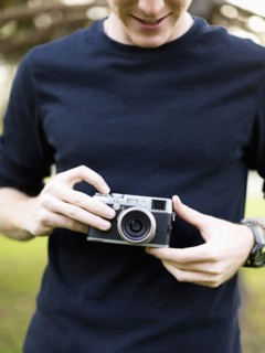 Young man holding camera