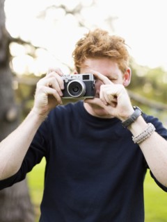 Portrait of young man taking photos