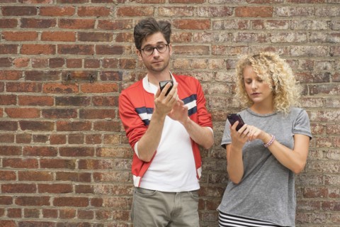 Couple using cell phones.