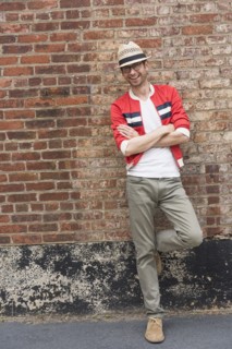 Portrait of mid adult man in front of brick wall.
