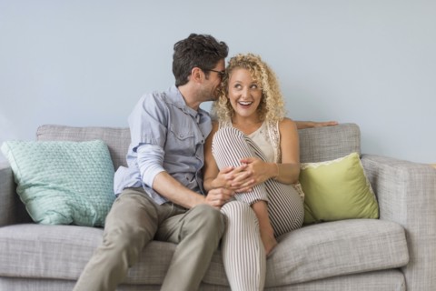 Couple sitting on sofa.