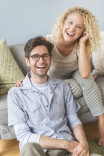Portrait of couple in living room.