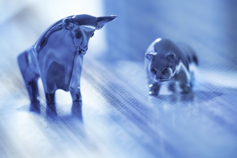 Digital composite with ceramic animals and financial newspaper.