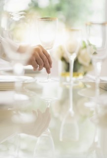 Close up of man's hand setting place in restaurant.
