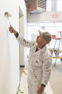 Manual worker painting wall.