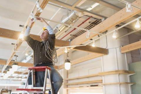 Electrician fixing lightning equipment.