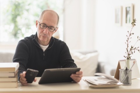 Mature man working in home office .