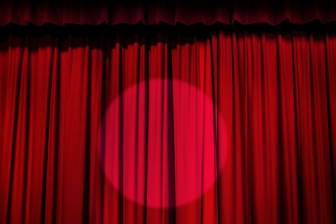 Spotlight on red curtain.
