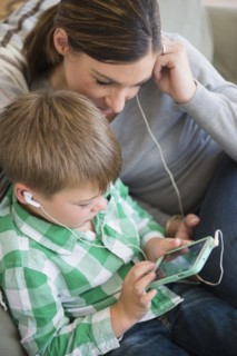 Mother and son (6-7) listening to music