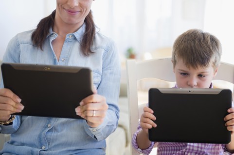 Mother and son (6-7) using digital tablet
