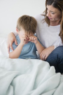 Mother consolling son (6-7)