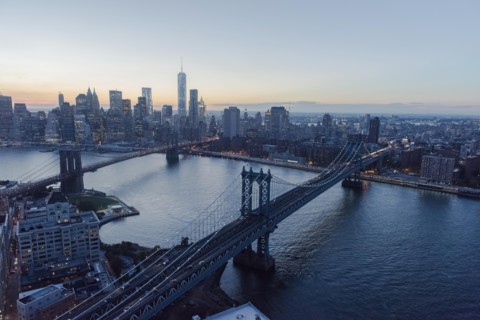 Lower Manhattan, View of Brooklyn Bridge and One World Trade Center at dusk