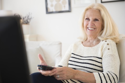 Senior woman holding remote control