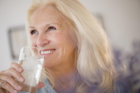 Portrait of senior woman drinking water