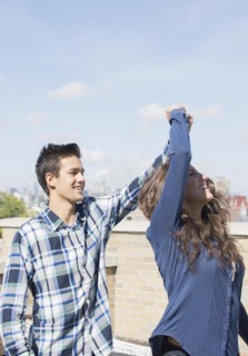 Young couple dancing on roof