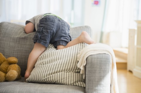 Boy (2-3) playing on sofa