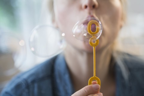 Woman blowing bubbles