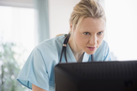 Doctor looking at computer monitor