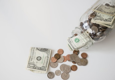 Studio Shot of banknotes and coins in jar