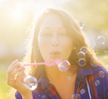Woman blowing bubbles