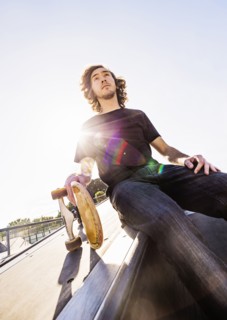 Skateboarder resting in skatepark