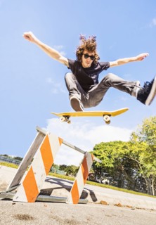 Man jumping on skate board in construction site