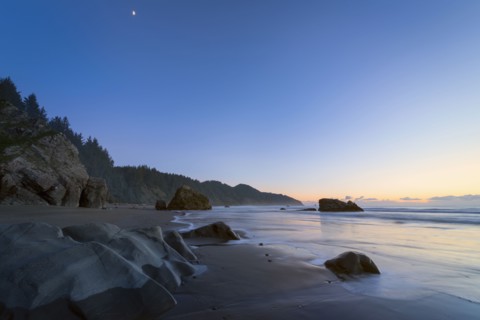 Scenic view of coastline at sunset