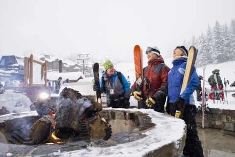 Group of friends with bonfire in winter
