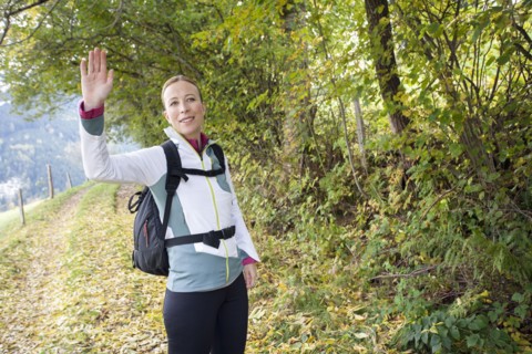 Woman waving at camera