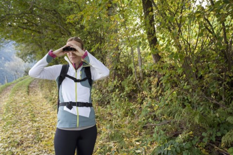 Woman looking through binoculars
