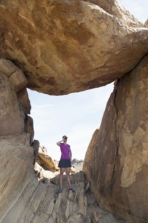 Woman visiting Balanced Rock, looking through binoculars