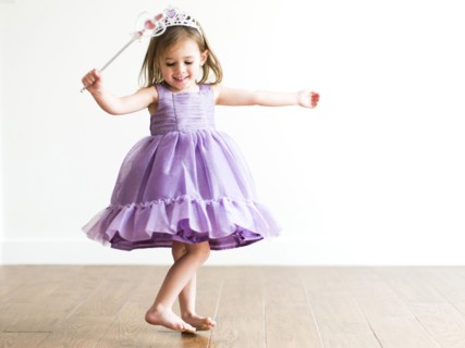Girl (4-5) in princess costume dancing