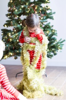 Girl (4-5) decorating christmas tree