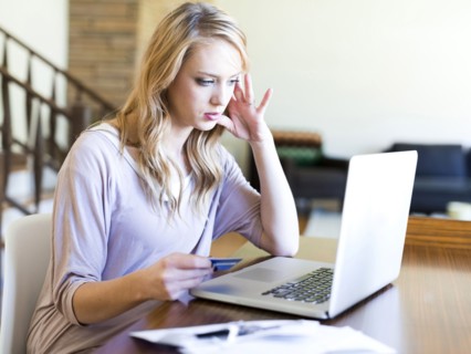Young woman using laptop at table