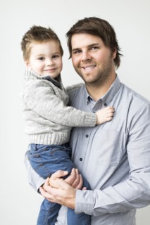 Smiling father holding son (2-3)