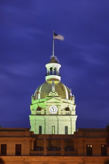City hall clock tower illuminated in green