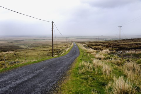 Rural country road runs through barren countryside