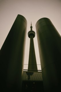 Low angle, symmetrical view of built structure and communications tower